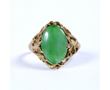 Jade single stone ring the oval jade cabochon in claw setting, between pierced and engraved dragon shoulders, yellow precious