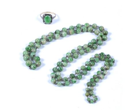 Jade bead necklace  compromising a single string of graduated beads, and a jade cabochon and marcasite dress ring (all jade u