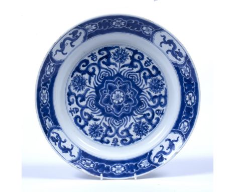 Blue and white dish  Chinese, Kangxi (1662-1722) decorated centrally with a floral motif surrounded by five Indian lotus flow