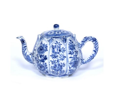 Blue and white teapot Chinese, Kangxi (1662-1722) decorated in panels of flowers with a diamond shaped base, the handle and s