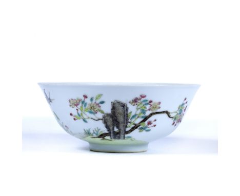 Famille rose bowl Chinese, 19th Century decorated to one side with a tall rock behind which a tree spreads out it's foliated 