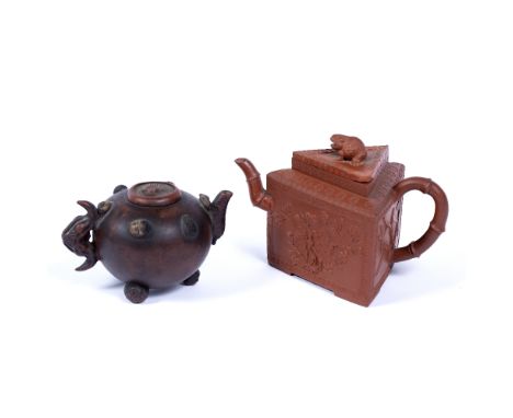 Two Yixing teapots Chinese, 19th Century the first with 'hundred fruits' decoration to the sides, the handle and the spout mo