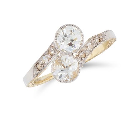 A DIAMOND CROSSOVER RING in yellow gold, set with two old round cut diamonds within a twisted band, accented by  and rose cut