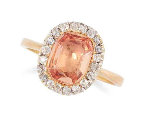 AN IMPERIAL TOPAZ AND DIAMOND CLUSTER RING set with a cushion cut topaz of 2.10 carats in a cluster of round old cut diamonds