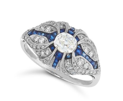 A DIAMOND AND SAPPHIRE RING in Art Deco design, set with a principle old cut diamond in a border of step cut sapphires and ro