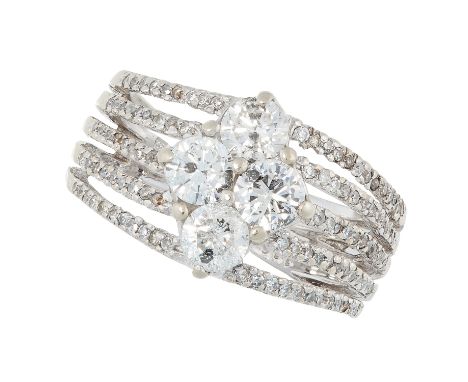 A DIAMOND DRESS RING comprising of four principle round cut diamonds on a five band ring set with further round cut diamonds,