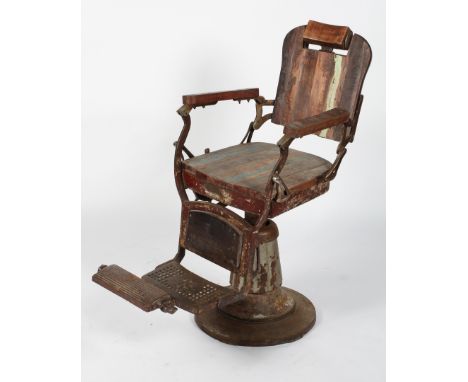 A vintage stripped wood and metal barber's chair, with revolving seat, adjustable head rest and folding footrest, 110cm high