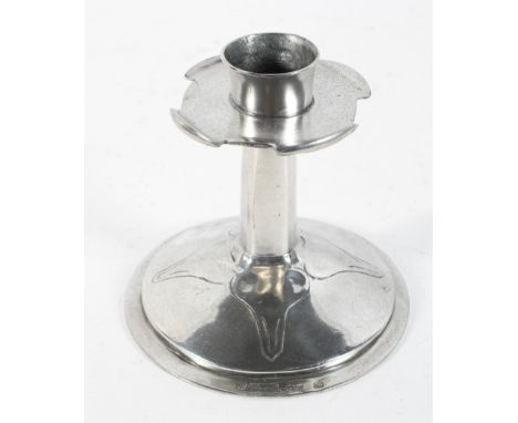 An Arts and Crafts pewter candlestick, the quatre lobe drip tray  on a circular base with raised decoration, stamped Made in 