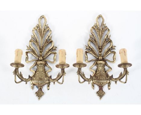 A pair of ornate brass two light wall sconces, 20th century, each vase-shaped issuing scrolling leaves and flowers, electrifi