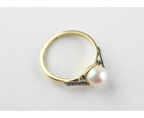 A yellow and white metal ring. Principally set with a 7.0mm cultured pearl (untested) and finished with rose cut diamond shou
