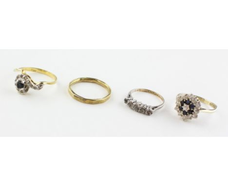 A collection of four dress rings. Three are marked for silver of variable standards. Size ranges from K to R. Gross weight: 8