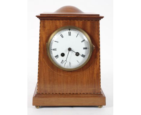 A French mantel clock. the 41/2" enamelled dial on a brass eight day movement, half hourly striking to a gong, with key, 27cm