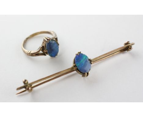 A yellow metal opal doublet single stone ring together with matching bar brooch. Tests as gold of approximately 9ct standard.