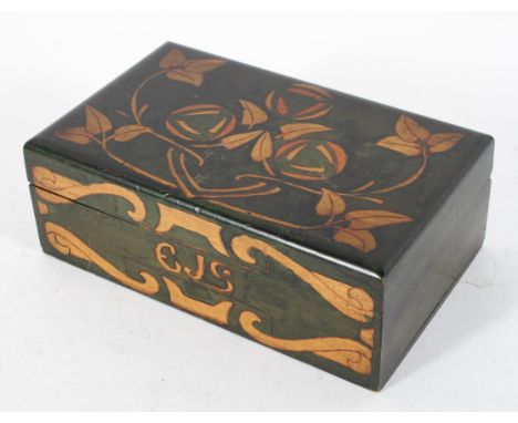 A Scottish Arts and Crafts wooden box and cover, decorated with C R Mackintosh style roses and foliage on a green ground, ini