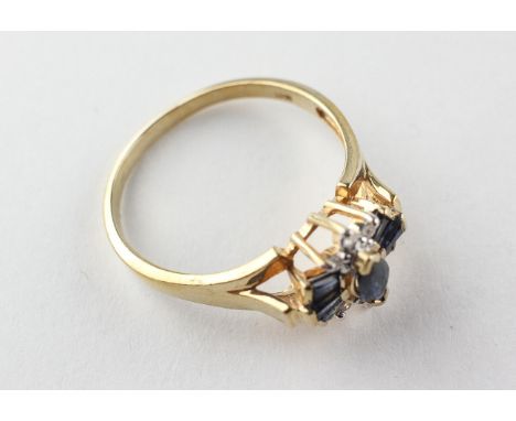 A yellow metal dress ring set with marquise/baguette cut sapphires and finished with diamonds. No hallmark - tests indicate 9