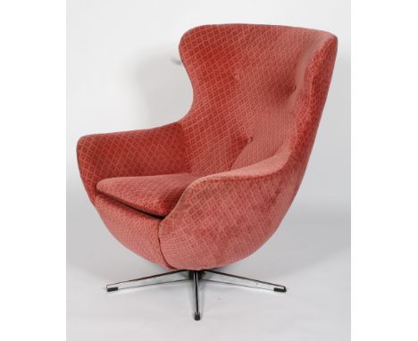 A 1960's vintage swivel egg chair having button backed upholstery and raised on a four point swivel base, 94cm high