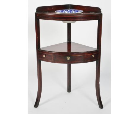 A 19th century mahogany corner washstand, with a low gallery, three openings and single shelf with a drawer, with a Spode blu