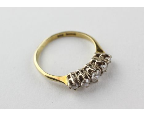 A yellow and white metal half hoop ring set with five graduated old European cut diamonds estimated to weigh a total of 0.50c