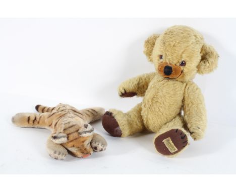 A Steiff tiger cub, asleep, no button, 25cm high; and a Merrythought golden plush teddy bear, 30cm high (2)