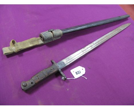 A WWI Period USA Bayonet, 42cm blade clearly stamped "1917" and "W", leather and metal scabbard with later canvass frog, spri