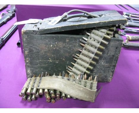 A WWI Era Vickers Machine Gun Ammunition Box, with belt and a number of spent rounds.
