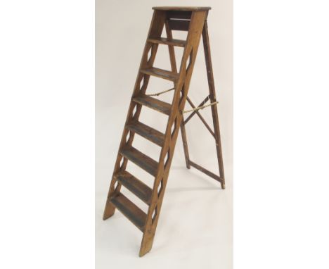 A VICTORIAN PINE STEP LADDER with seven steps joined with brass hinged arms, 155cm high Condition Report: Available upon requ