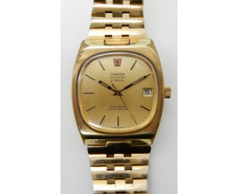 A GOLD PLATED GENTS OMEGA ELECTRONIC F300 HZ GENEVE CHRONOMETER the retro style watch has a rounded square gold coloured dial