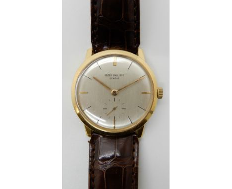 AN 18CT GOLD PATEK PHILIPPE WRISTWATCH with brushed silvered dial, gold coloured baton numeral and a further subsidiary secon