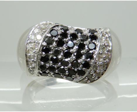 A 9CT WHITE GOLD BLACK AND WHITE DIAMOND DRESS RING finger size O, weight 7.1gms Condition Report: Light general wear. 