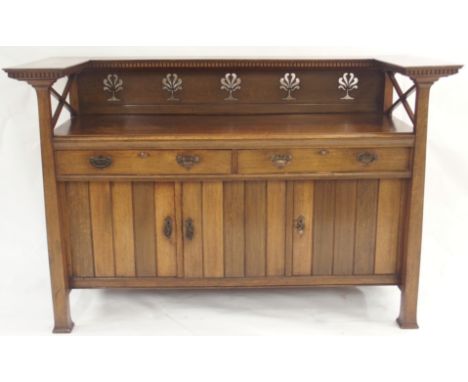 AN OAK ARTS AND CRAFTS SIDEBOARD with a dentil shelf over a pierced floral back panel and X-frame sides over a base with two 