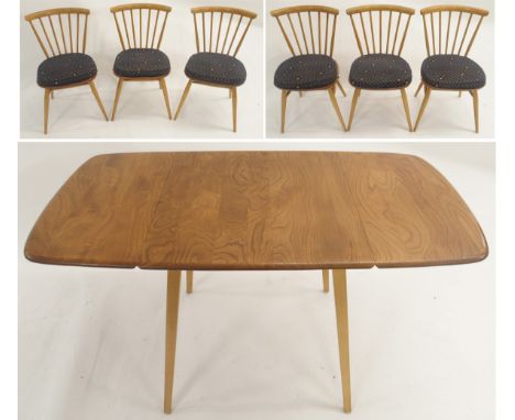 A LIGHT ERCOL ELM DROP-LEAF DINING TABLE 71cm high x 135cm wide x 71cm deep with six stick back chairs with Ercol seat pads, 