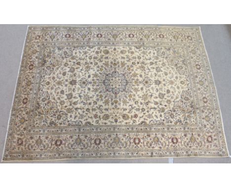 A LIGHT GROUND KASHAN RUG with central medallion and floral border, 334cm x 245cm Condition Report: Available upon request