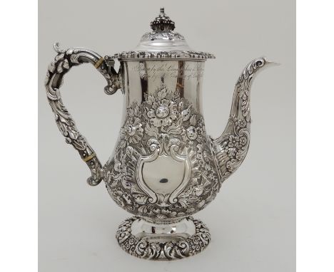 A GEORGE IV SILVER COFFEE POT by Thomas and John Settle, Sheffield 1821, of baluster form with scrolling handle and bird's he