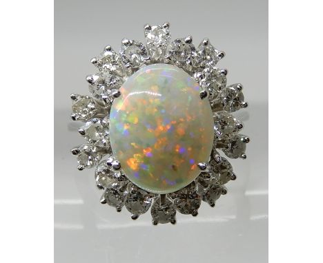 AN 18CT WHITE GOLD OPAL AND DIAMOND CLUSTER RING the white opal is approx 10.7mm x 8.6mm and further set with a double halo o