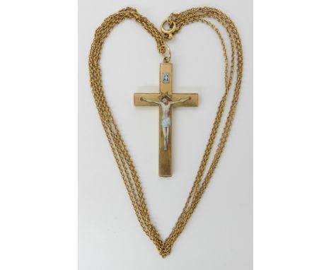 A YELLOW METAL CRUCIFIX WITH ENAMELLED CHRIST craftsman made, inscribed verso 'Agnus Dei' with initials, dimensions including