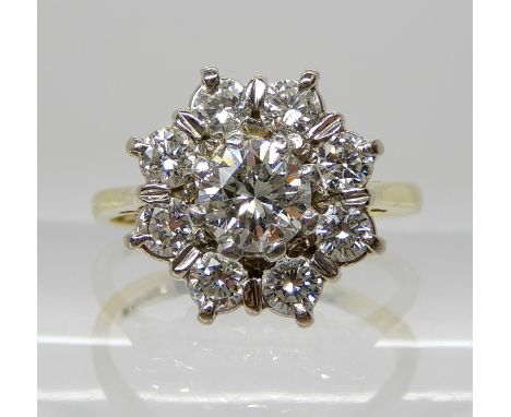 AN 18CT GOLD DIAMOND FLOWER RING set with estimated approx 1ct of brilliant cut diamonds, finger size K1/2, weight 3.7gms Con