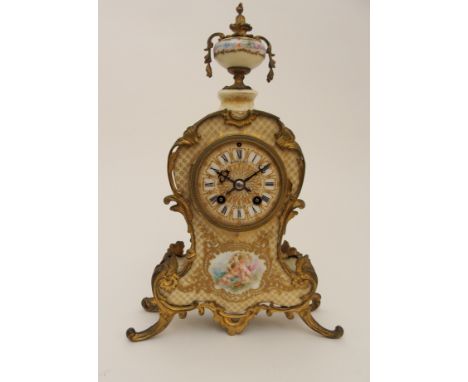 A VICTORIAN GILT METAL AND PORCELAIN MANTEL CLOCK the front with decoration of cherubs surrounded by gilded cross hatching, t