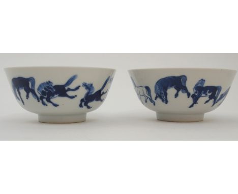 A PAIR OF CHINESE BLUE AND WHITE BOWLSpainted with The Eight Horses of Wang Mu, bearing Kangxi marks, 12cm diameter, another 