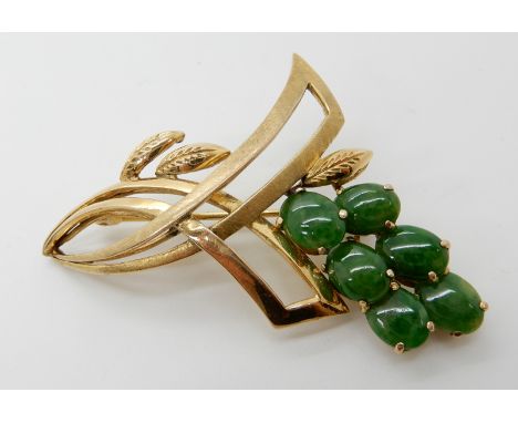 A 14K GOLD CHINESE GREEN HARDSTONE BROOCH RETAILED BY LIBERTYS the foliate design is set with six oval cabouchons of approx 8