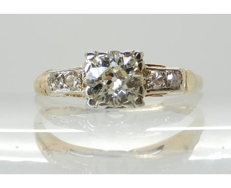 A VINTAGE OLD CUT DIAMOND RING set with an estimated approx 0.40ct old cut diamond in white metal setting, with further diamo