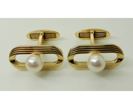 A PAIR OF YELLOW METAL PEARL SET CUFFLINKS stamped K14, the retro oval faces set with a pearl of approx 7mm, weight 10.8gms C