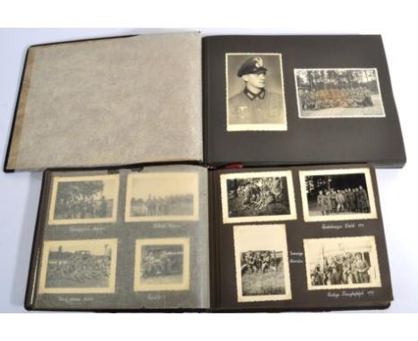 A German Third Reich Period Photograph Album, the cover relief with a white metal German Army helmet, containing approx. 220 