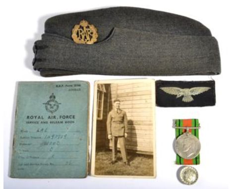 A Second World War RAF Side Cap, with brass cap badge and black horn buttons, a pair of printed cloth eagle shoulder insignia