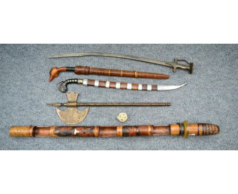 An Indonesian Golok, with 54cm single edge fullered steel blade, the horn hilt carved as the head of a stylised parrot applie