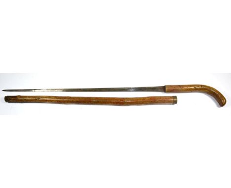 A Late 19th Century Bamboo Sword Stick, the 65cm single edge steel blade with a narrow fuller running along the back edge, wi