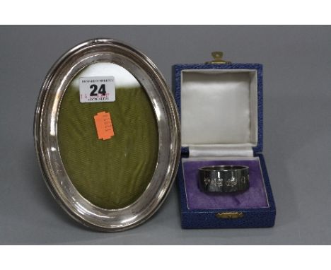 AN EDWARDIAN SILVER OVAL PHOTOGRAPH FRAME, oak easel back, inner dimensions 13cm x 8.7cm, Birmingham 1910, together with a Bi