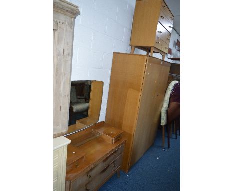 A LIGHT OAK THREE PIECE BEDROOM SUITE, comprising of a dressing table, chest of four drawers and a two door wardrobe (Lebus b