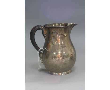 A LATE VICTORIAN SILVER MILK JUG OF BALUSTER FORM, leather covered handle, makers Daniel & John Welby, London 1900, 14.9ozt, 