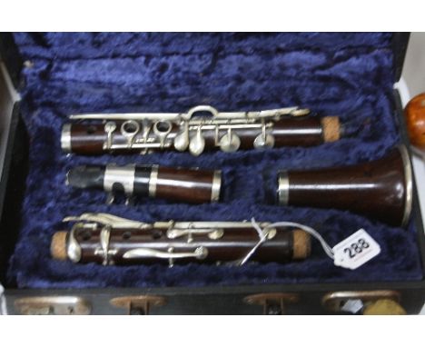 A CASED ROSEWOOD CLARINET, stamped Douglas & Co.