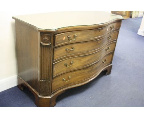 A 20TH CENTURY MAHOGANY SERPENTINE FRONTED GRADUATED CHEST OF FOUR LONG DRAWERS, with brass swan neck handles and bracket fee